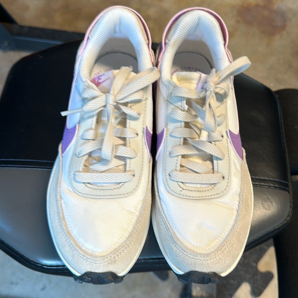 Nike white with purple swoosh women’s running shoes.